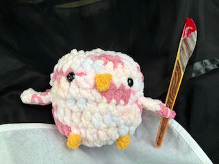 Crochet bird with plastic colored knife